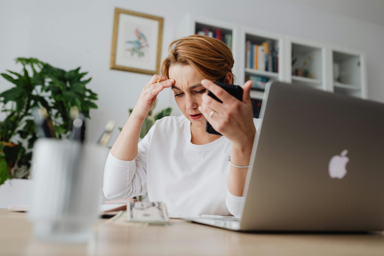 Woman on the phone with a creditor, worried about bills, before filing bankruptcy in Arkansas